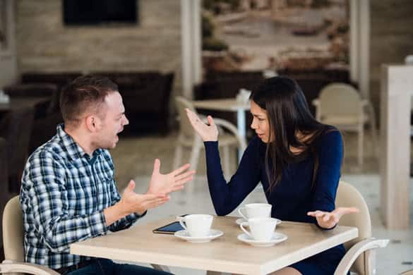 Young couple arguing in a cafe