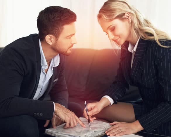 Young manager flirting with businesswoman in sunset