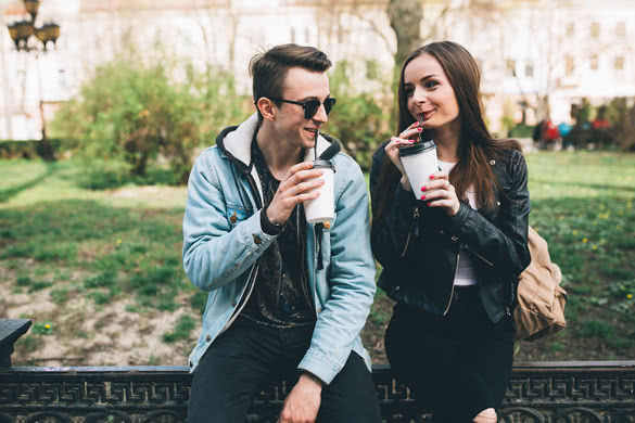 Youth and fashionable couple on the streets drinking coffee