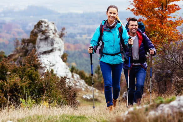 Couple Backpackers hiking on the path in mountains during autumn