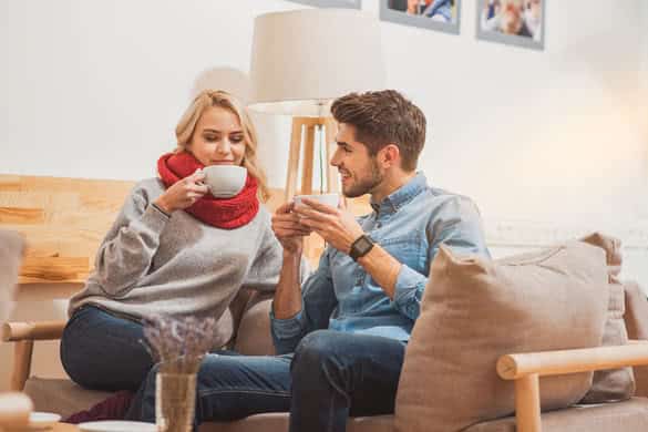 Happy man and woman enjoying hot drink