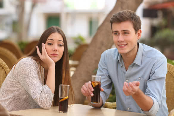 Man and woman dating in a restaurant terrace but she is boring while he telling lies with the street 6