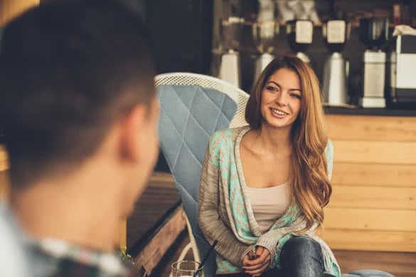 Young woman and man flirting each other in cafe