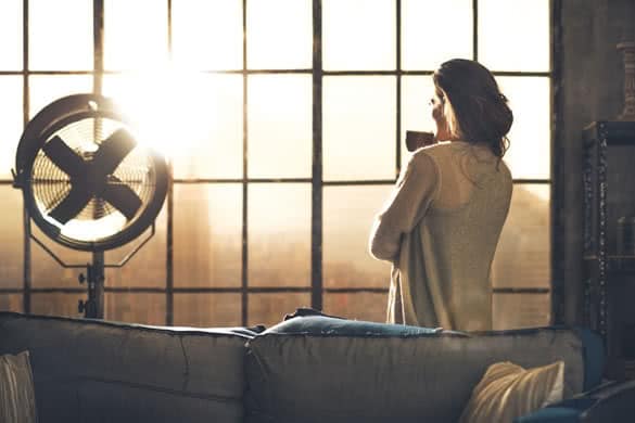 Young woman enjoying cup of coffee in loft apartment