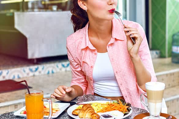 woman eating breakfast in a restaurant 