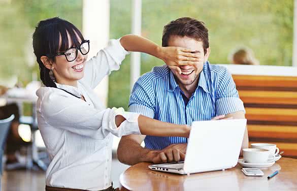 woman hiding laptop from her man