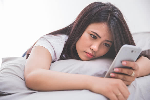 young brunette looking at her phone