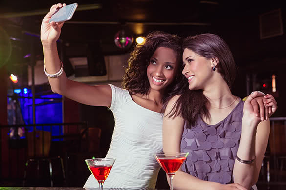 women taking a selfie in a club