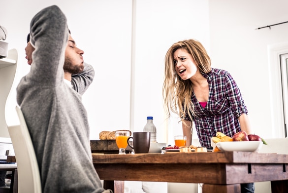 young couple fighting at a table during breakfast