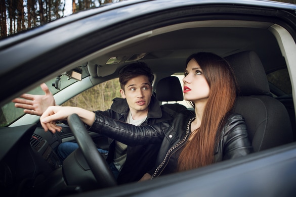 young couple arguing in a car