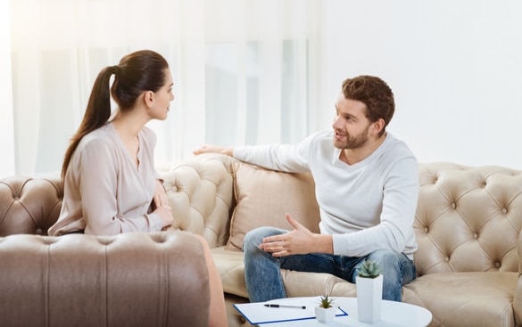 couple talking on a couch